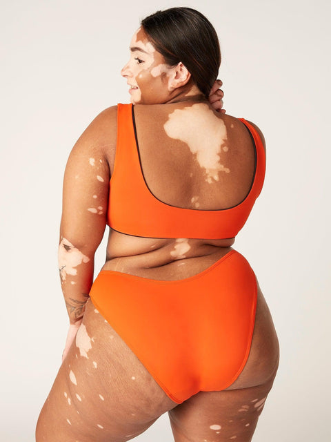 Modibodi Recycled Swimwear Brazilian Brief Sunset Orange|ModelName: Onella 16/XL